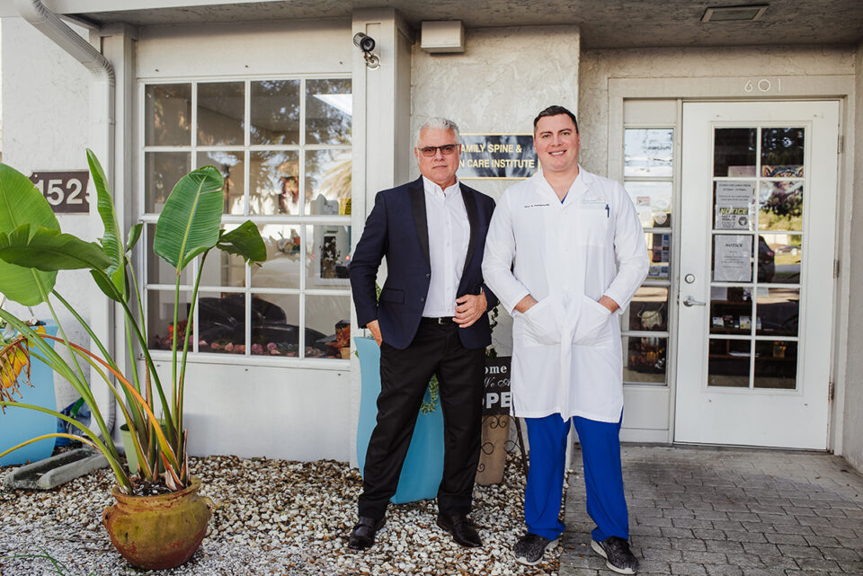 Two men standing outside a building.