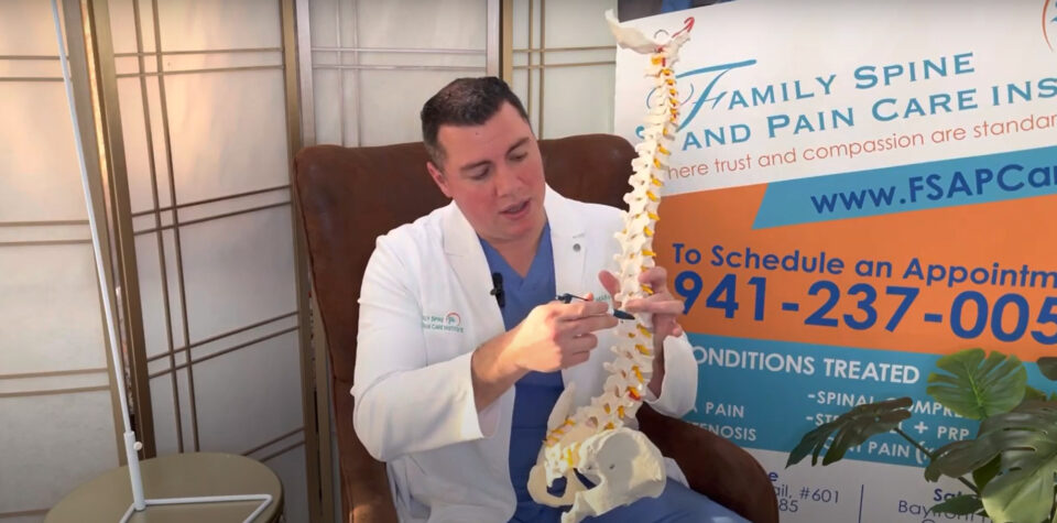 A man in a white coat holding a skeleton model. A man in a white coat holding a skeleton model.