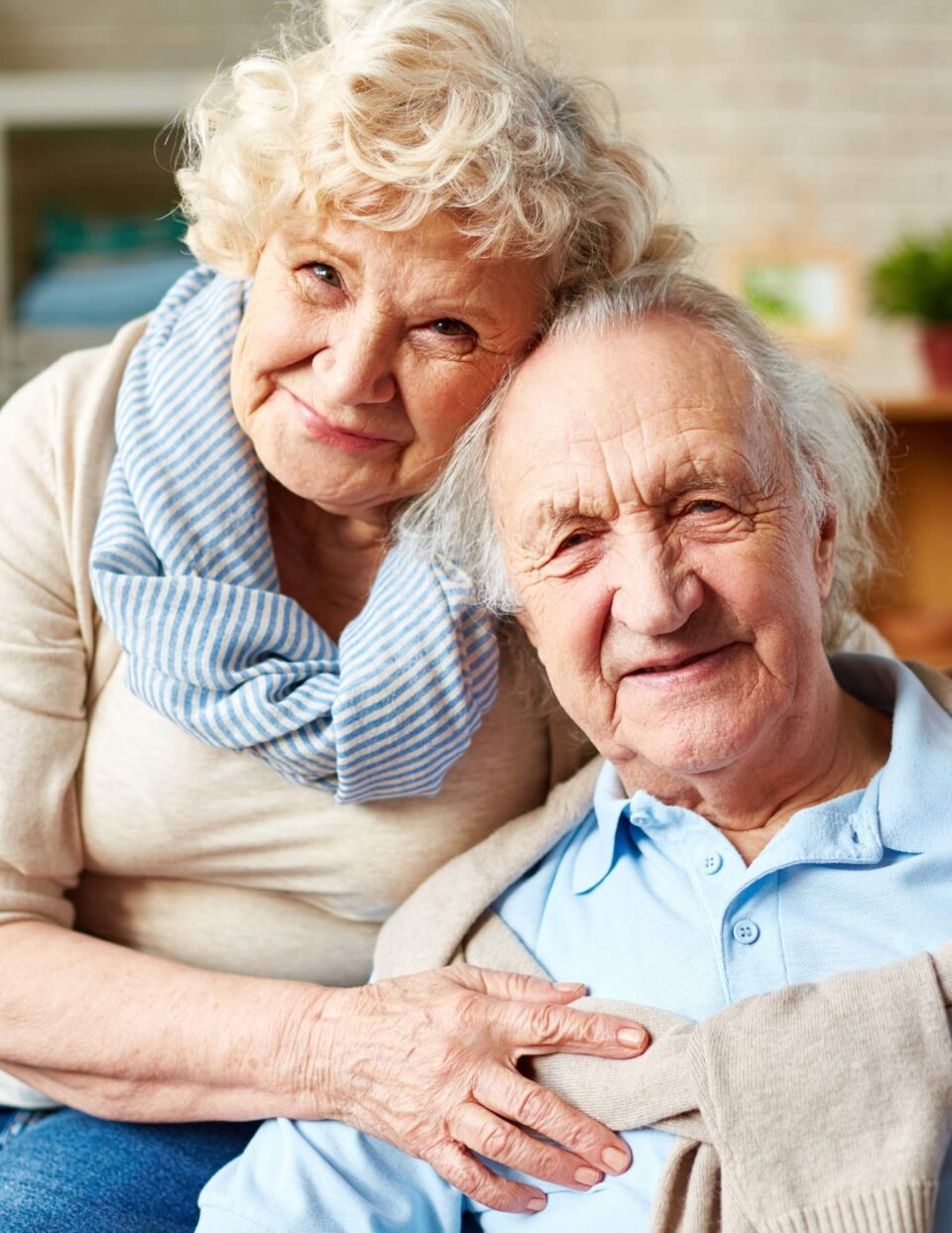 An older couple hugging each other.