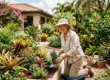 An older woman kneels on a garden pad, planting flowers in a raised garden bed in a lush, colorful backyard. Gardening tools and a basket are nearby. she is smiling experiencing pain-free gardening.