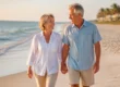 Active senior couple walking happily on a Venice, Florida beach, symbolizing mobility and relief from spinal stenosis pain via minuteman procedure.